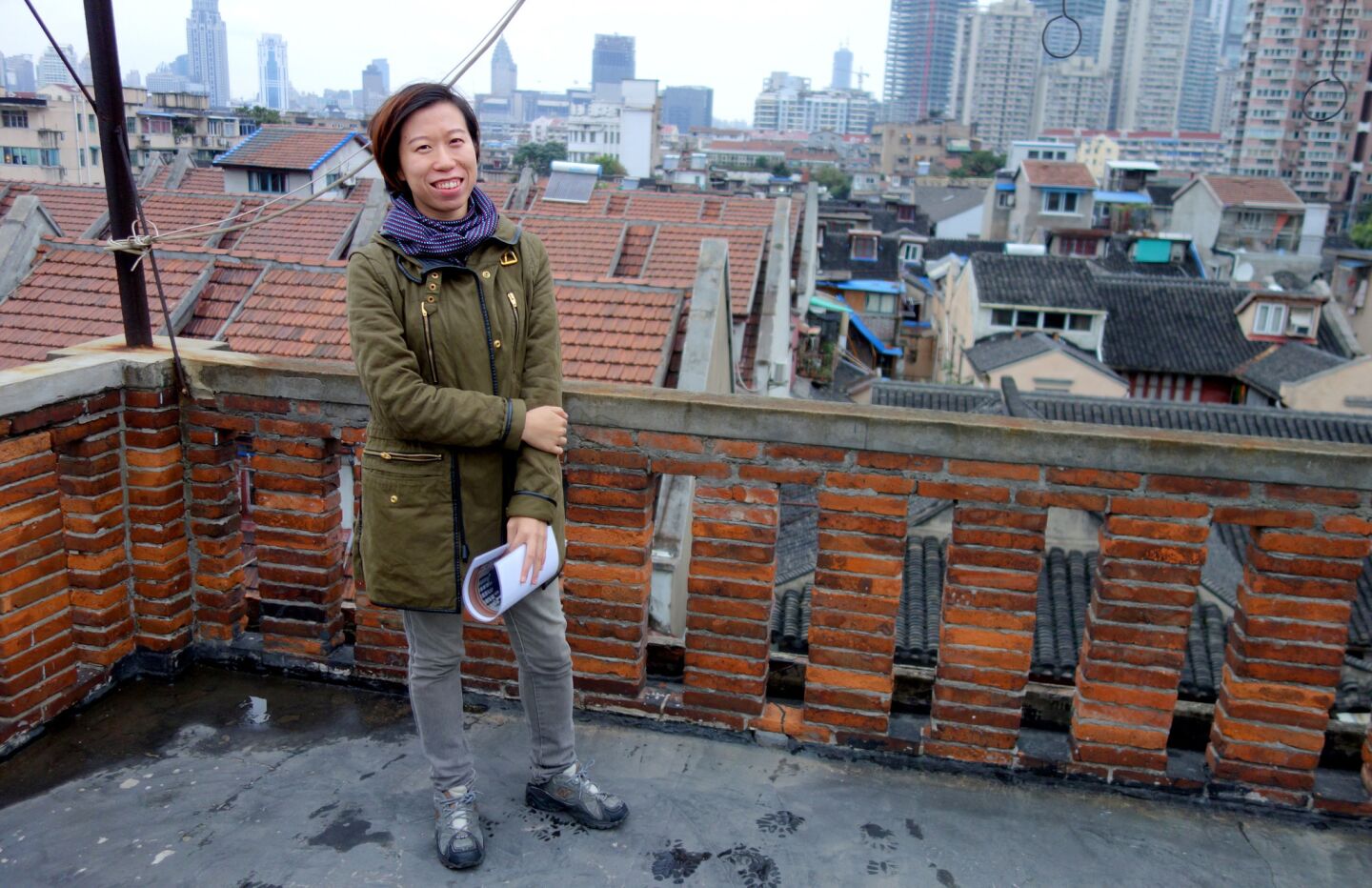 Janny Chyn, the owner of custom touring agency Shanghai Pathways, on a rooftop in the Old City of Shanghai.