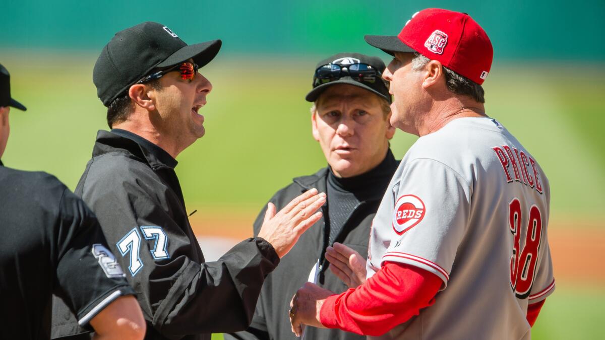 Cincinnati Reds Manager Brian Price, right, argues with umpire Jim Reynolds before the start of Saturday's game against the Cleveland Indians.