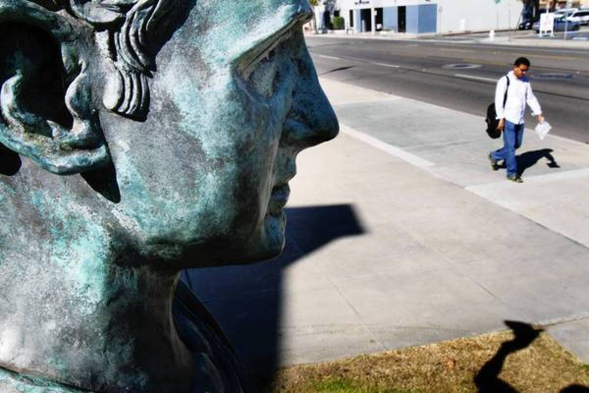 A statue of Alex Odeh stands next to the rear entrance of Santa Ana Main Library. Odeh was a Palestinian American civil rights leader who was killed when a pipe bomb exploded in his office.