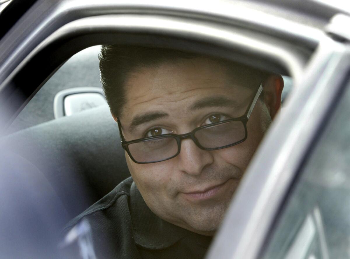 Former South Gate Treasurer Albert T. Robles is shown in an FBI vehicle after his arrest in 2004.