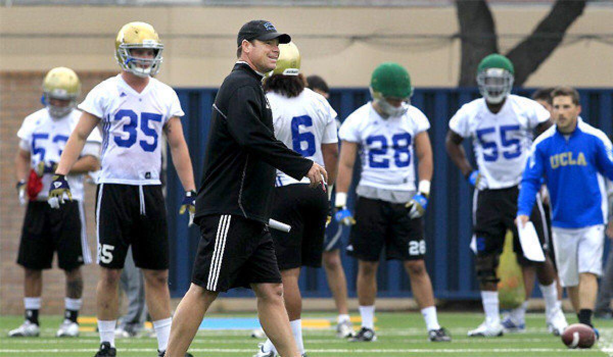 UCLA football Coach Jim Mora watches spring practice on April 2.