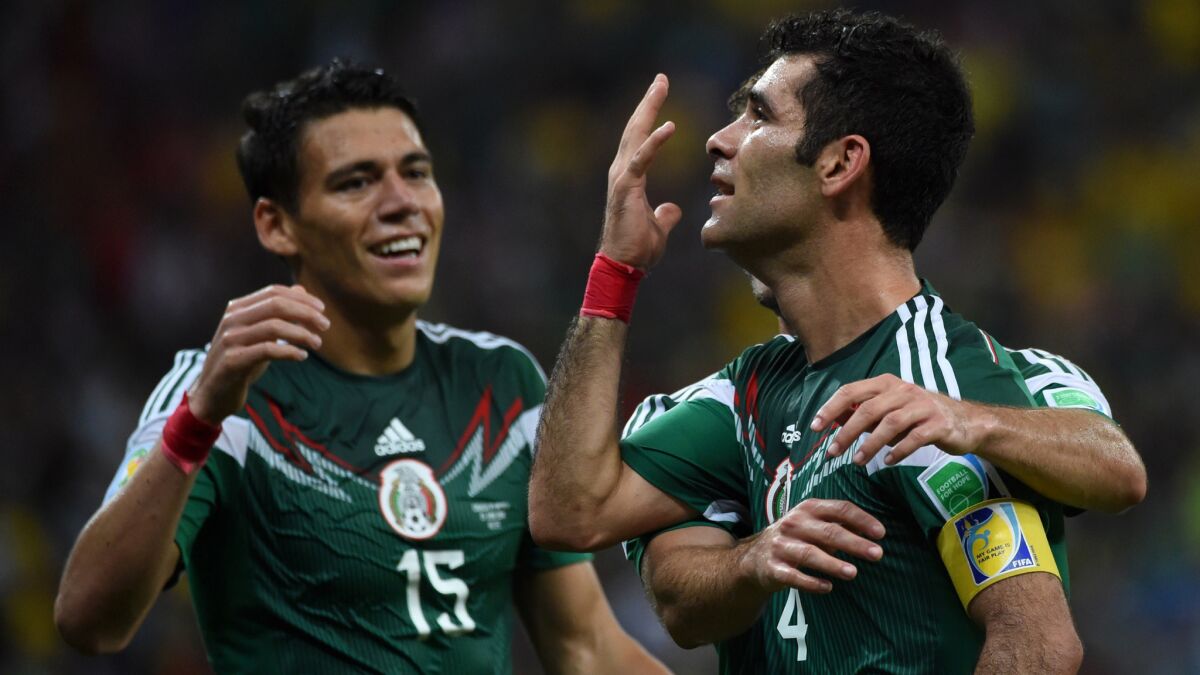 Mexico defender Rafael Marquez, right, celebrates with teammate Hector Moreno, left, after scoring his team's first goal in a 3-1 World Cup victory over Croatia on Monday.