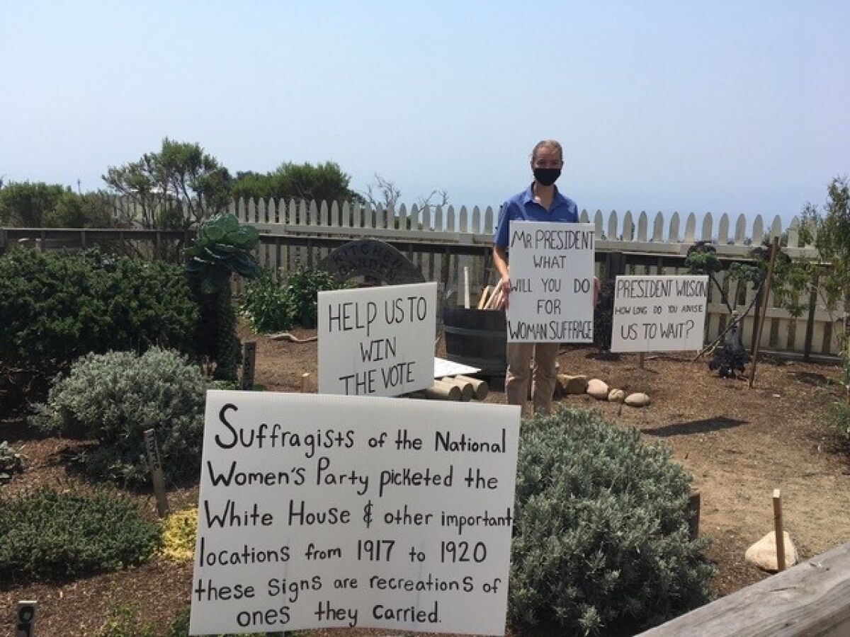 Posing in the “picket garden,” Sita Antel re-created signs from past protests.