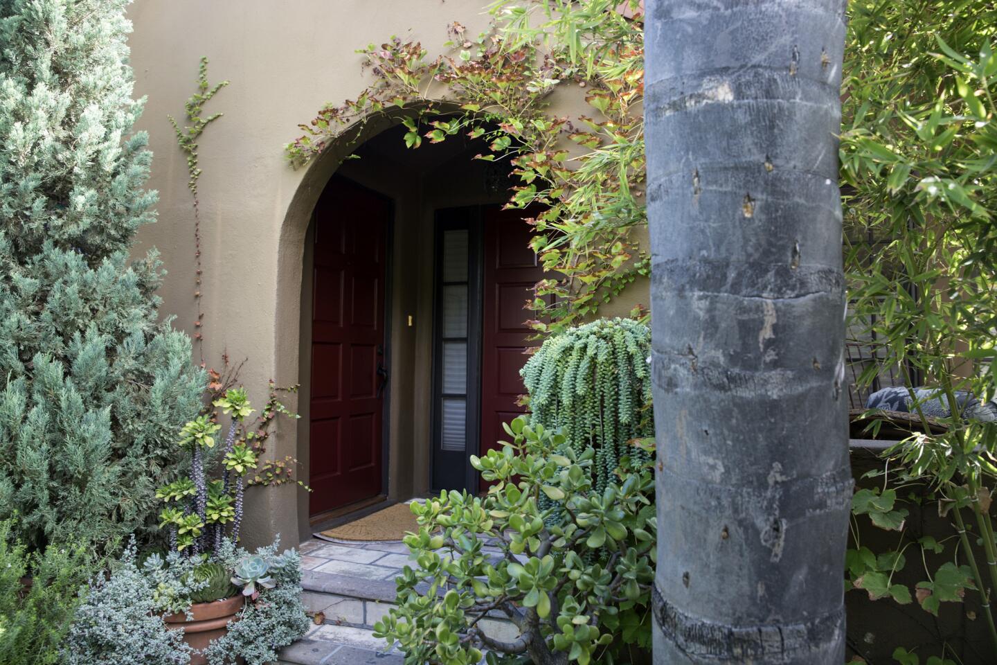 At left, the door to Tommy Chambers' home, and at right, the door to his interior design firm. He completely gutted and updated the 1923 row house after downsizing from a 4,000-square-foot house in the Hollywood Hills.