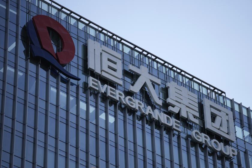 FILE - The Evergrande Group headquarters logo is seen in Shenzhen in southern China's Guangdong province, on Sept. 24, 2021. Share trading of debt-laden Chinese property developer China Evergrande Group was suspended in Hong Kong on Thursday, Sept. 28, 2023, according to a notice on the Hong Kong stock exchange. (AP Photo/Ng Han Guan, File)