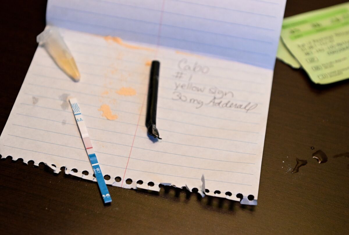 A testing strip on a white piece of notebook paper