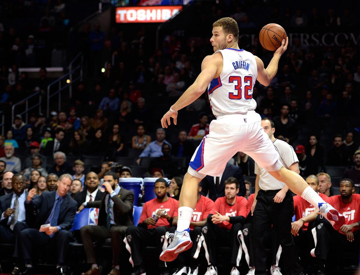 Blake Griffin saves the ball from going out of bounds and turns to send it back to one of his teammates during the Clippers' 123-84 win over the Brooklyn Nets at Staples Center.