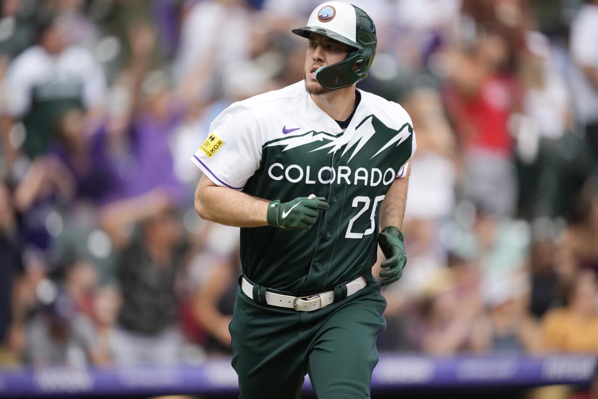 Colorado Rockies' C.J. Cron looks to the dugout as he heads up the first base line after hitting a three-run home run off Arizona Diamondbacks relief pitcher Noe Ramirez during the eighth inning of a baseball game Sunday, July 3, 2022, in Denver. (AP Photo/David Zalubowski)
