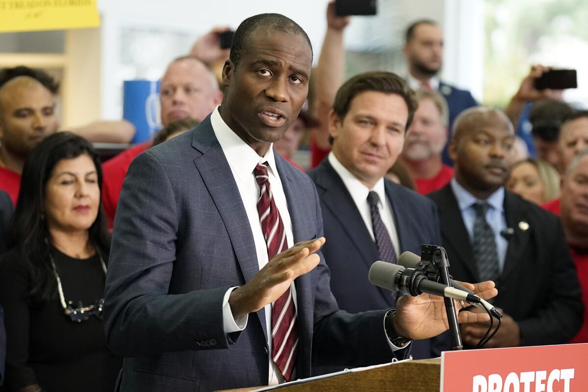 Florida Surgeon General Joseph Ladapo gestures while speaking.