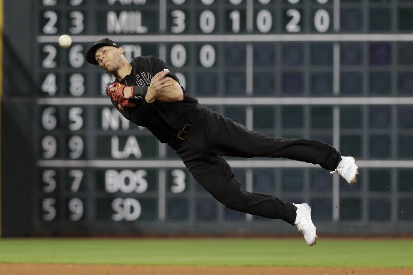 Los Angeles Angels shortstop Andrelton Simmons throws to first base for the out after fielding a ground ball by Houston Astros' George Springer during the seventh inning of a baseball game Friday, Aug. 23, 2019, in Houston. (AP Photo/David J. Phillip)