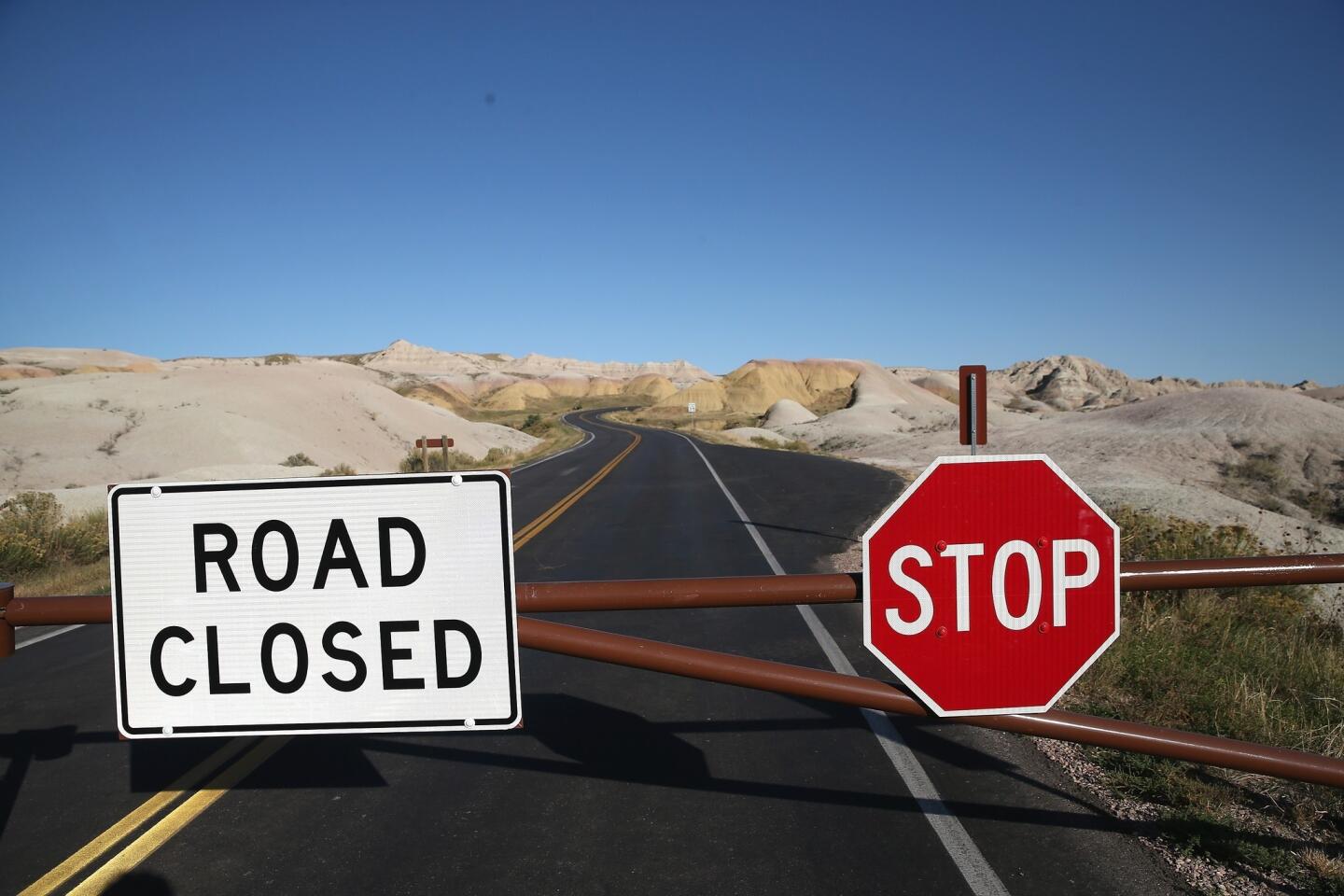 A barricade prevents visitors from entering the interior of the Badlands National Park near Wall, S.D. All national parks were closed after Congress failed to pass a temporary funding bill.