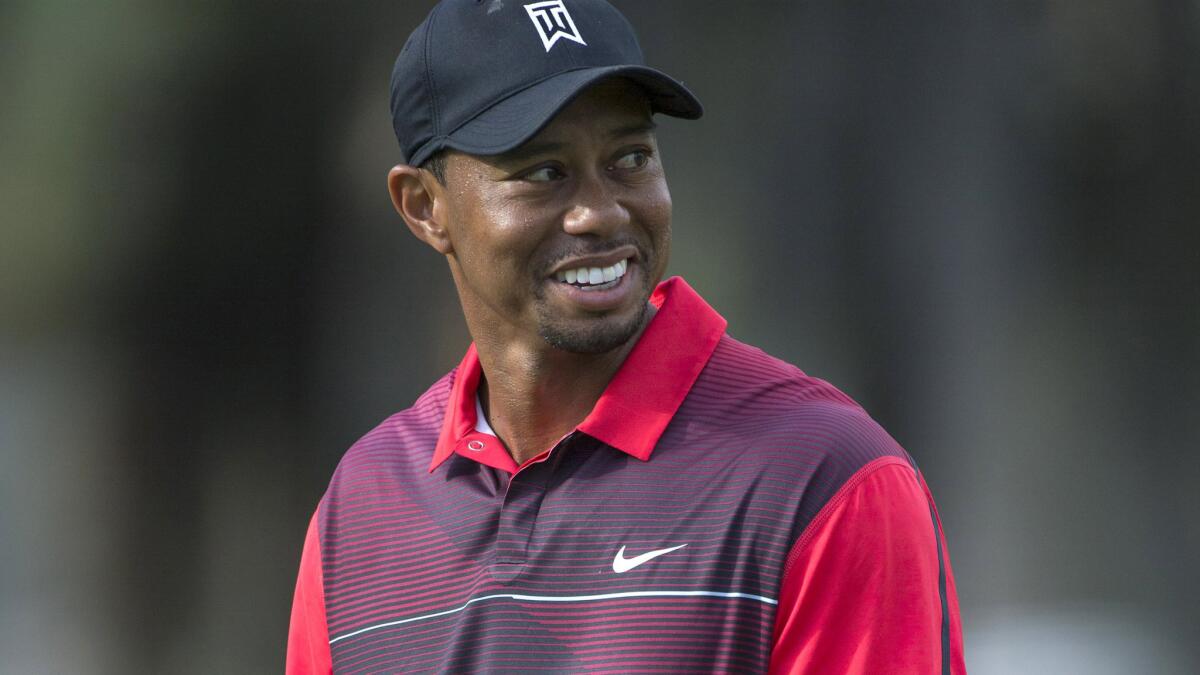 Tiger Woods smiles while standing on the 18th green during the final round of the Hero World Challenge in Windermere, Fla., on Dec. 7.