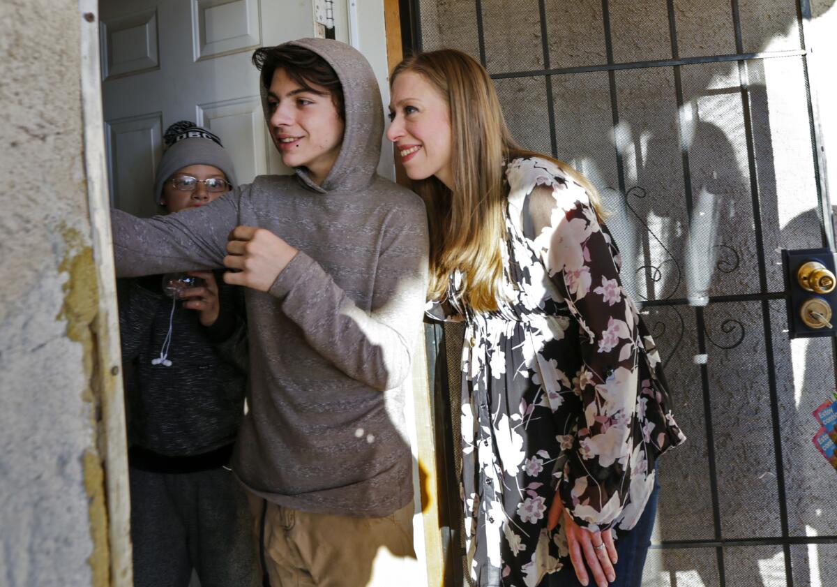 Chelsea Clinton, right, went door-to-door in Las Vegas on Friday, asking voters to support her mother, Hillary Clinton, at Saturday's Democratic caucuses in Nevada.