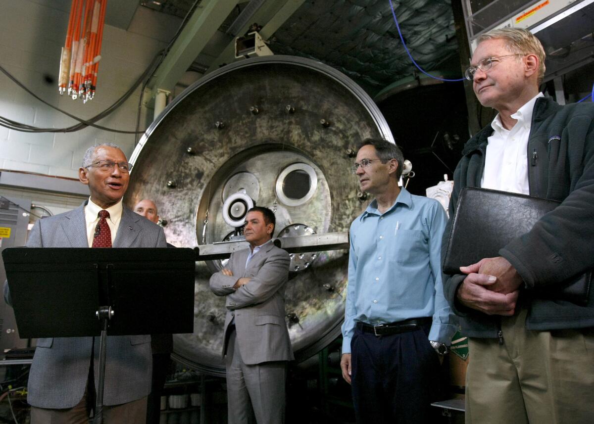 Surrounded by JPL officials, NASA Administrator Charles Bolden, left, talks about the Asteroid Initiative during press conference at the Jet Propulsion Laboratory in Pasadena on Thursday, May 23, 2013. NASA plans to capture an asteroid as it comes close to earth and set it in moon orbit for future exploration. The ion thruster will power a spacecraft that will capture the asteroid.