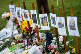 FILE - Rain soaked memorials for those who died in a mass shooting sit along the roadside by Schemengees Bar & Grille, Oct. 30, 2023, in Lewiston, Maine. An Army report released Tuesday, July 23, 2024, said three reserve officers have been disciplined for dereliction of duty in aftermath of reservist’s rampage in which 18 people were killed. (AP Photo/Matt York, File)