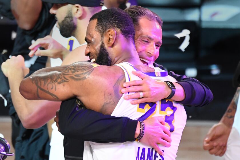 ORLANDO, FLORIDA OCTOBER 11, 2020- Lakers LeBron James hugs GM Rob Pelinka.