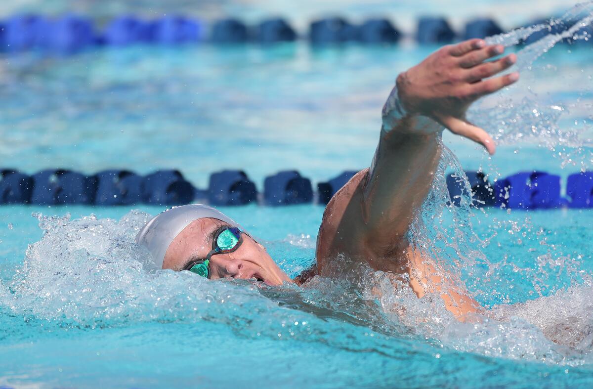 Newport Harbor's Aidan Arie swims to victory in the boys' 200 yard freestyle during Tuesday's Battle of the Bay swim meet.