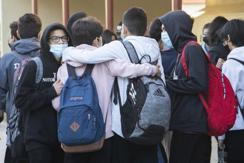 SYLMAR, CA - JANUARY 11: Students returned to campus, and friends, at Olive Vista Middle School in Sylmar on Tuesday, Jan. 11, 2022. Every student needed a negative COVID-19 test result. (Myung J. Chun / Los Angeles Times)