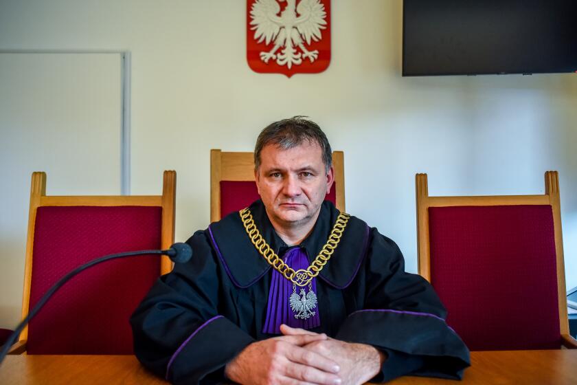 Waldemar Żurek, 50, a judge in the district court of Krakow, Poland, is one of dozens of judges who says the the right-wing Polish government is punishing him for upholding the law and criticizing the ruling party. He has faced death threats and has upcoming disciplinary trials for his conduct. He has denied the charges. He is pictured inside a courtroom in Krakow.