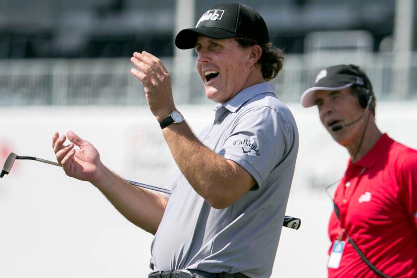 Phil Mickelson applauds after his playing partner made a birdie putt on the 18th hole of the Honda Classic Pro-Am in Palm Beach Gardens, Fla., on Wednesday.