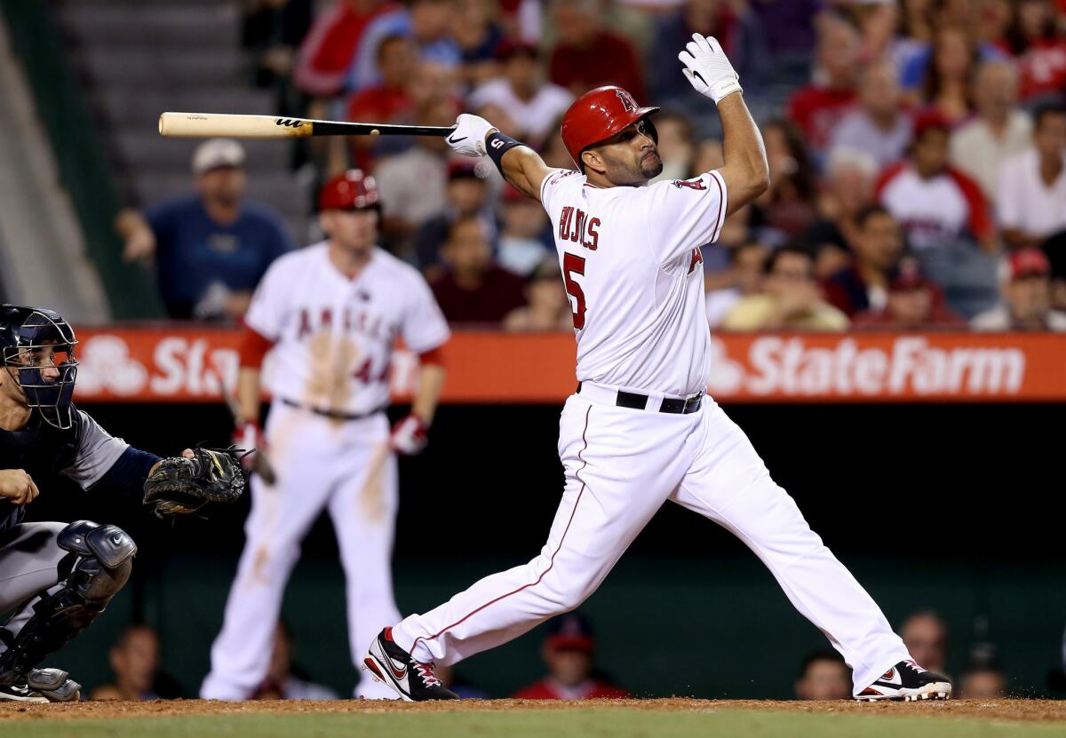 Angels' Albert Pujols hits an RBI double against the Seattle Mariners in the sixth inning at Angel Stadium.