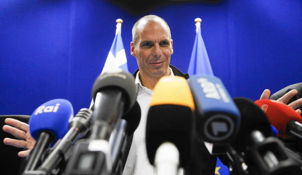 Greek and European financial officials agreed to extend the bailout terms while the two sides try to find a final deal over the staggering 320-billion euro (about $365 billion) debt and a series of economic reforms. Above, Greek Finance Minister Yanis Varoufakis at a news briefing Friday.