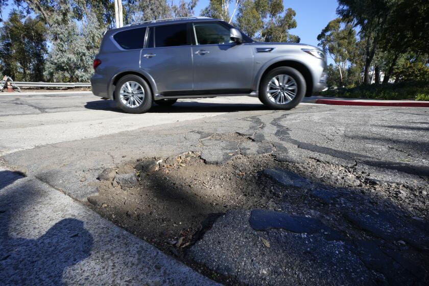 San Diego, CA - January 16: In the residential community on Quito Court in Tierrasanta, evidence of crumbling asphalt and cracks appears throughout the neighborhood streets. (Nelvin C. Cepeda / The San Diego Union-Tribune)