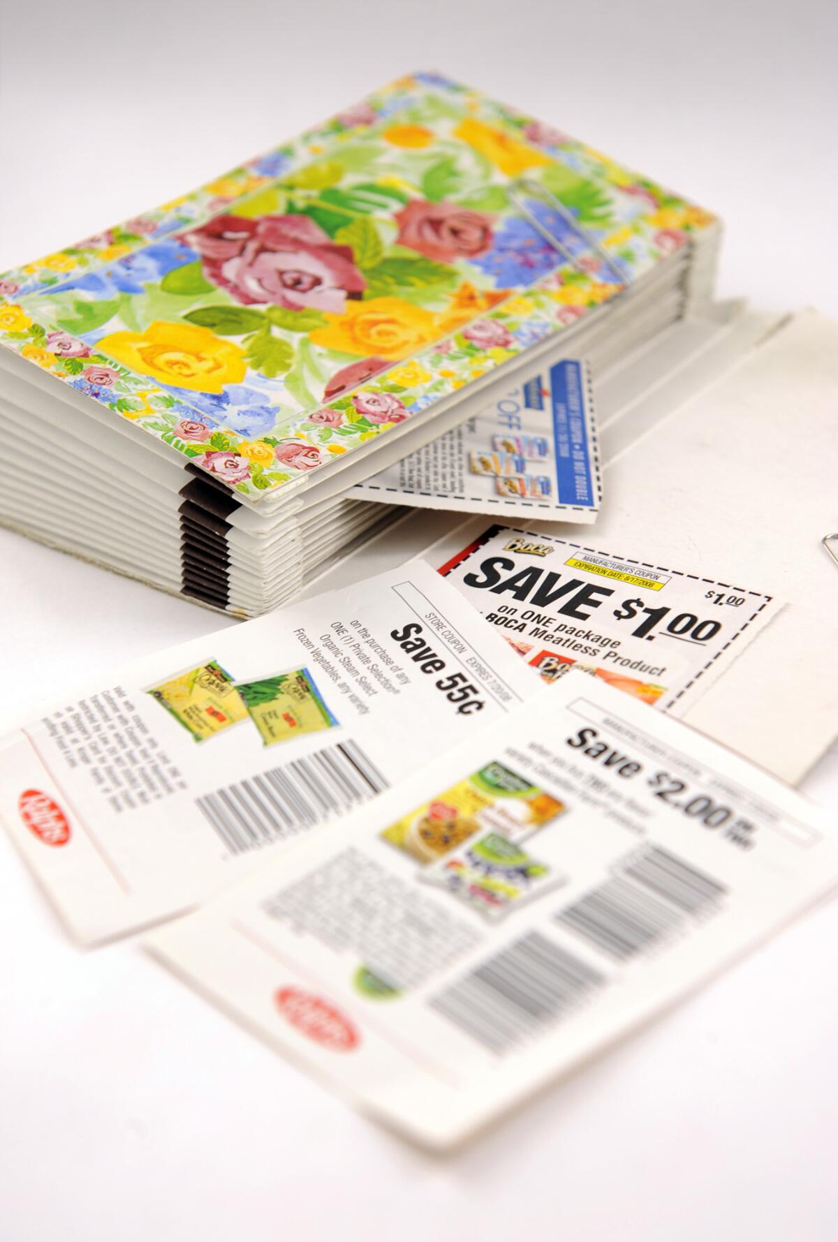 Tattered coupon folder and grocery coupons. 
