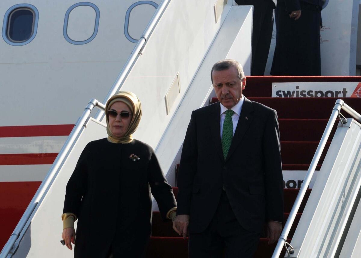Turkish President Recep Tayyip Erdogan, shown here on Wednesday arriving in Algiers with his wife, Emine, calls motherhood women's highest role and urges Turkish women to have at least three children.