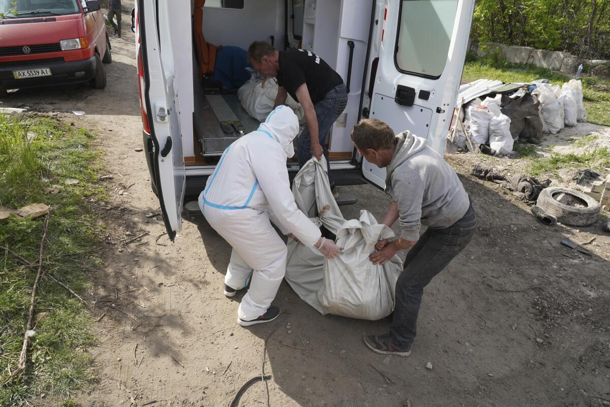 Volunteers removing body of Russian soldier in Ukraine.