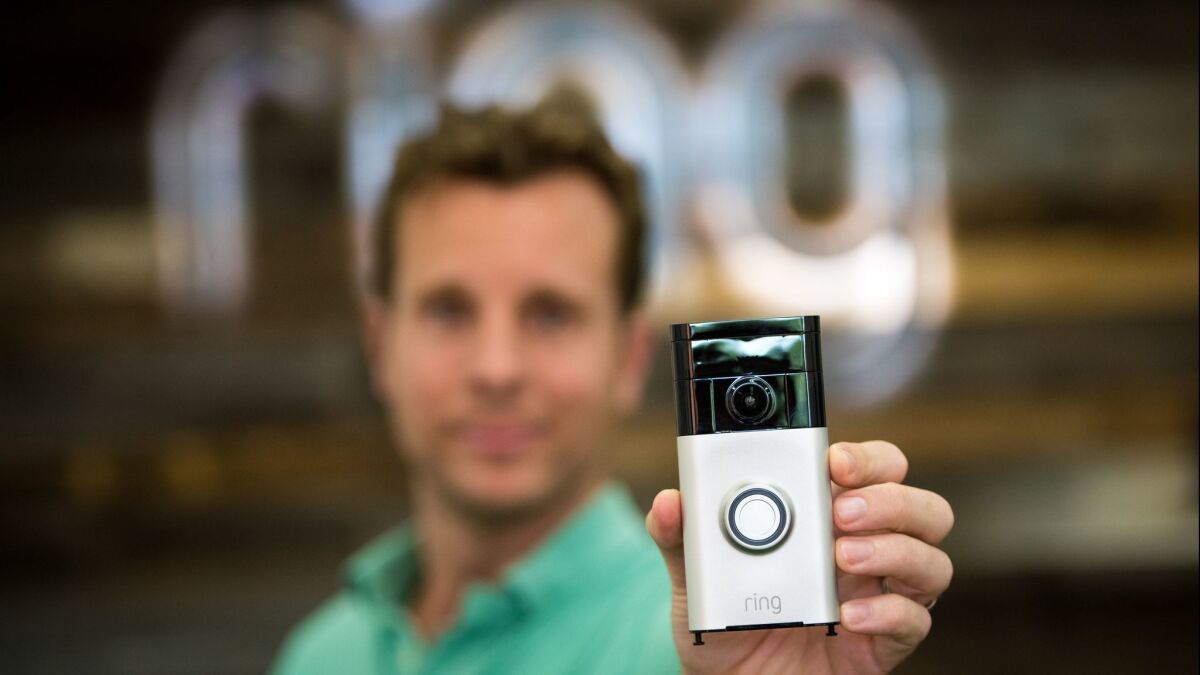 Ring founder and Chief Executive Jamie Siminoff holds a Ring doorbell.
