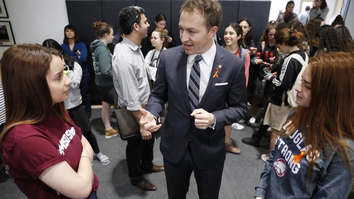 L.A. Unified Board of Education Vice President Nick Melvoin talks with Marjory Stoneman Douglas High School students Mia Freeman, left, and Hayley Licata.