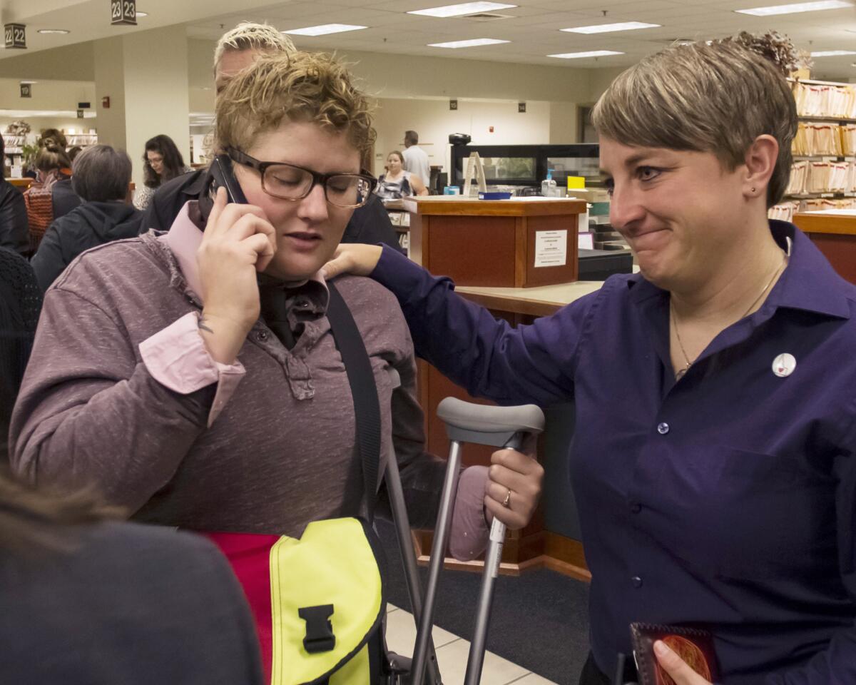 Rachael Beierle calls family to tell them she and Amber Beierle, right, would not be able to get married Wednesday in Boise after an order from Supreme Court Justice Anthony Kennedy temporarily put same-sex marriages on hold in Idaho. The order was vacated Friday.