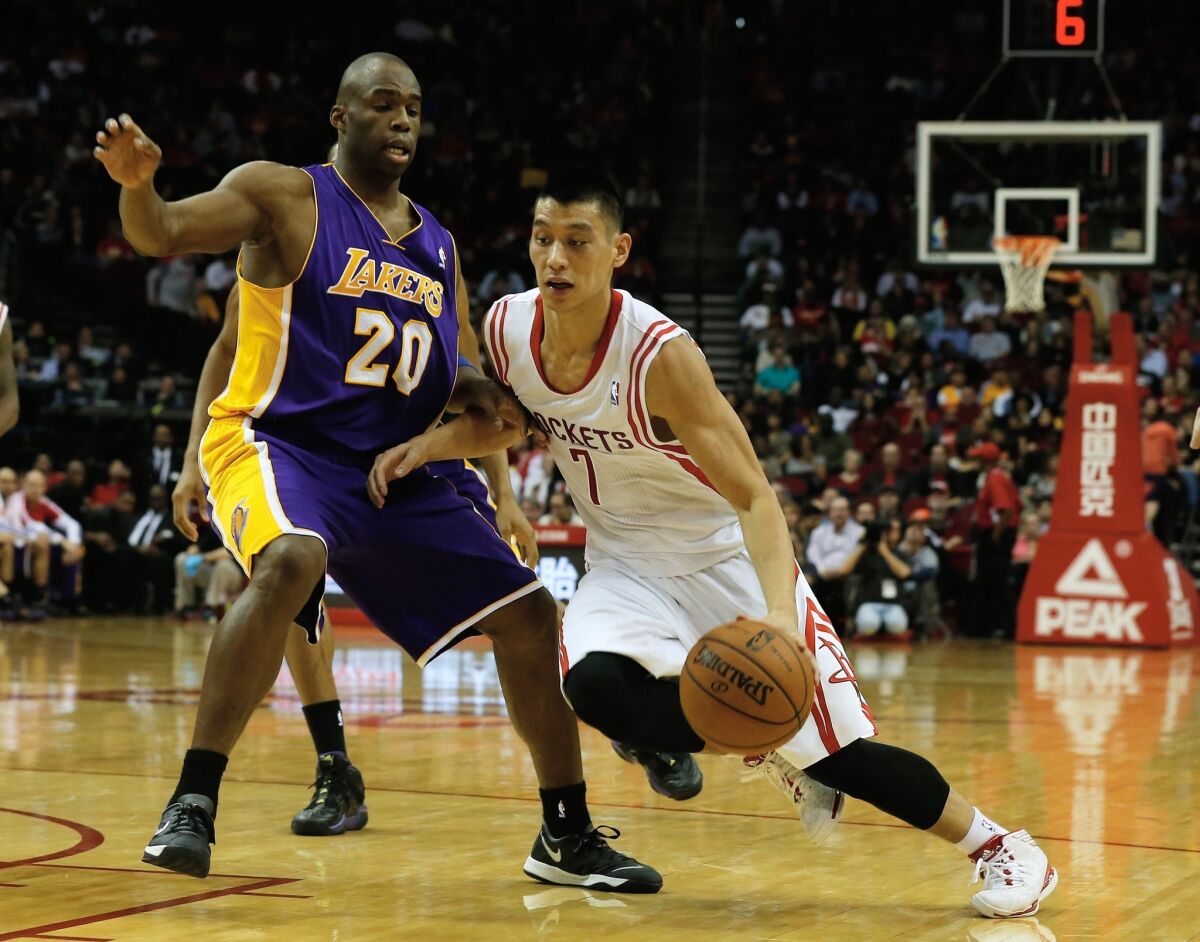 Houston Rockets point guard Jeremy Lin, right, drives against Lakers guard Jodie Meeks during the first half of Wednesday's game.