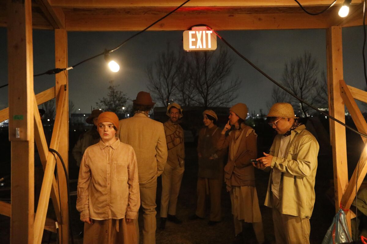 Performers with the Industry prepare to rehearse a scene from ”Sweet Land" at Los Angeles State Historic Park on Feb. 21, 2020.  