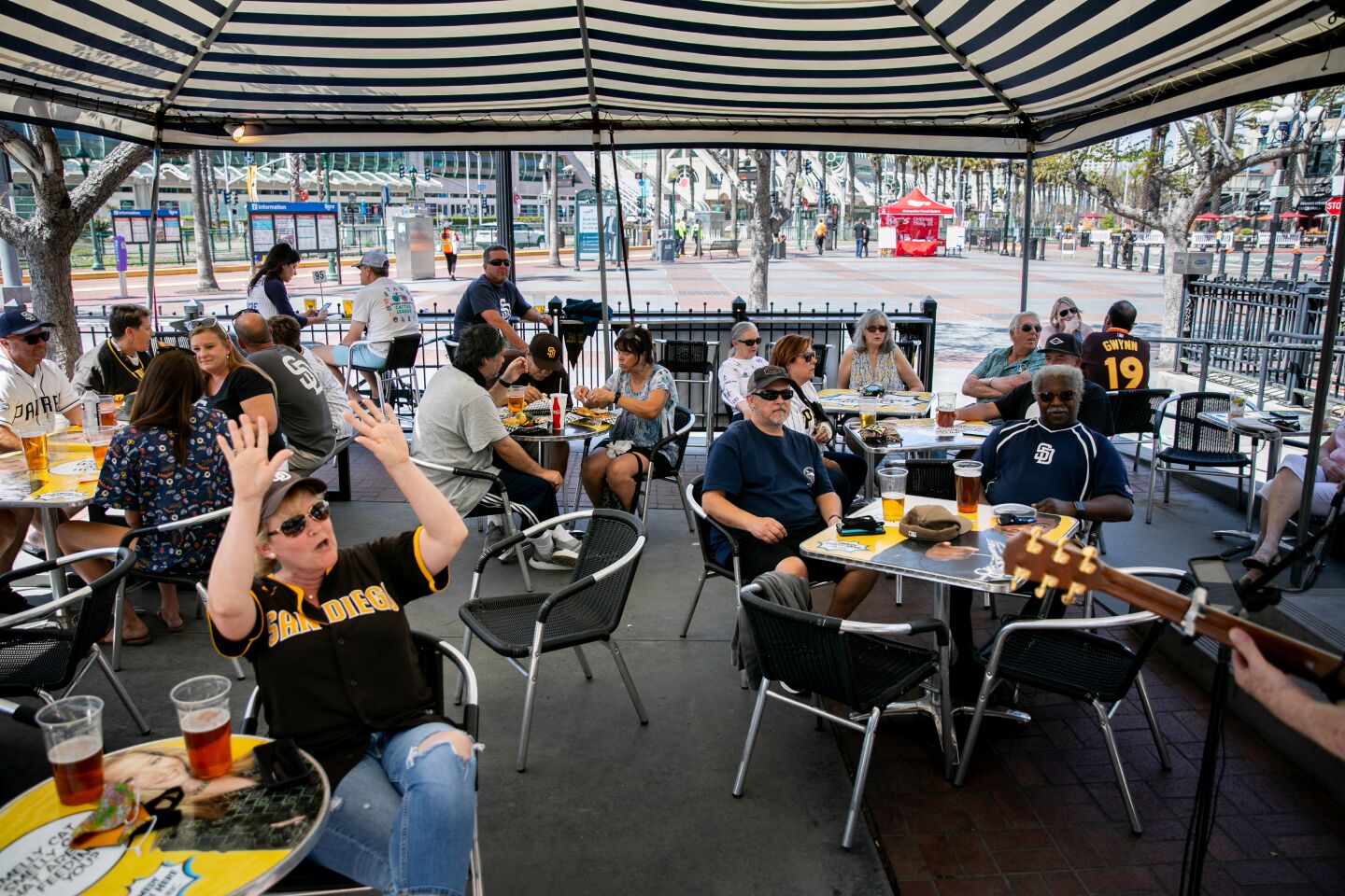 Padres fans take in a baseball-themed musical performance at The Tin Fish Gaslamp before the start of the Opening Day game between the San Diego Padres and the Arizona Diamondbacks in Downtown San Diego near Petco Park on Thursday, April 1, 2021 in San Diego, CA. The San Diego Padres welcomed a limited number of fans back into the stadium on Thursday for the first time since the beginning of the coronavirus pandemic.
