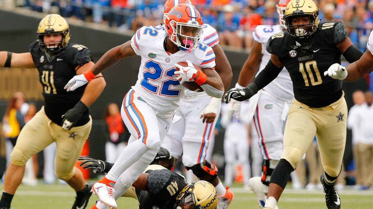 Florida's Lamical Perine rushes against Vanderbilt defenders during the first half on Saturday.