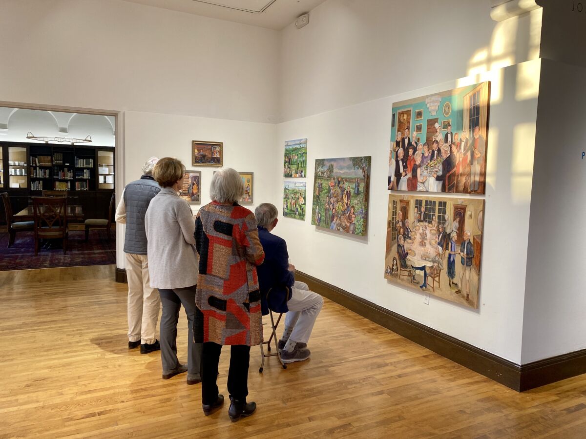 A small group views Paula McColl's paintings during the Athenaeum's first opening reception for an exhibit since March 2020.