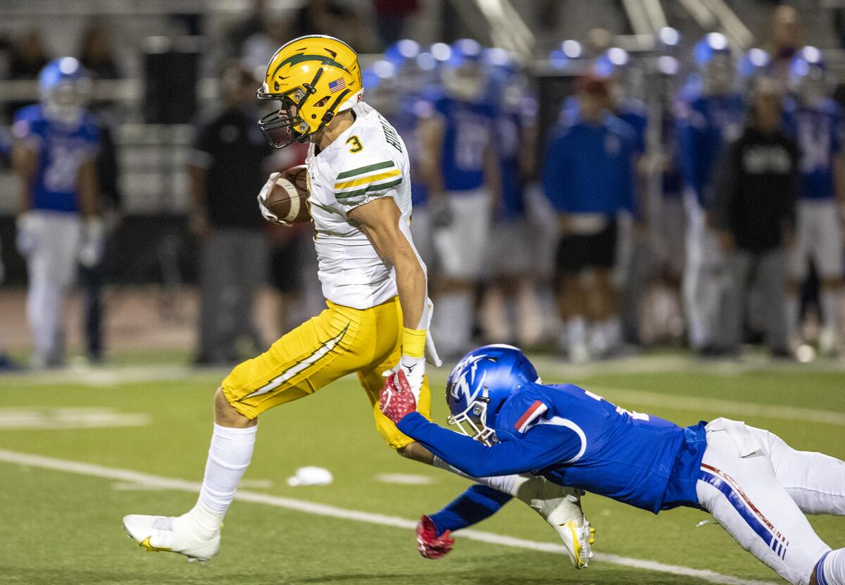 Edison's Ashton Hurley holds off Los Alamitos' Gavin Porch during a Sunset League game at Boswell Field on Oct. 7, 2021.