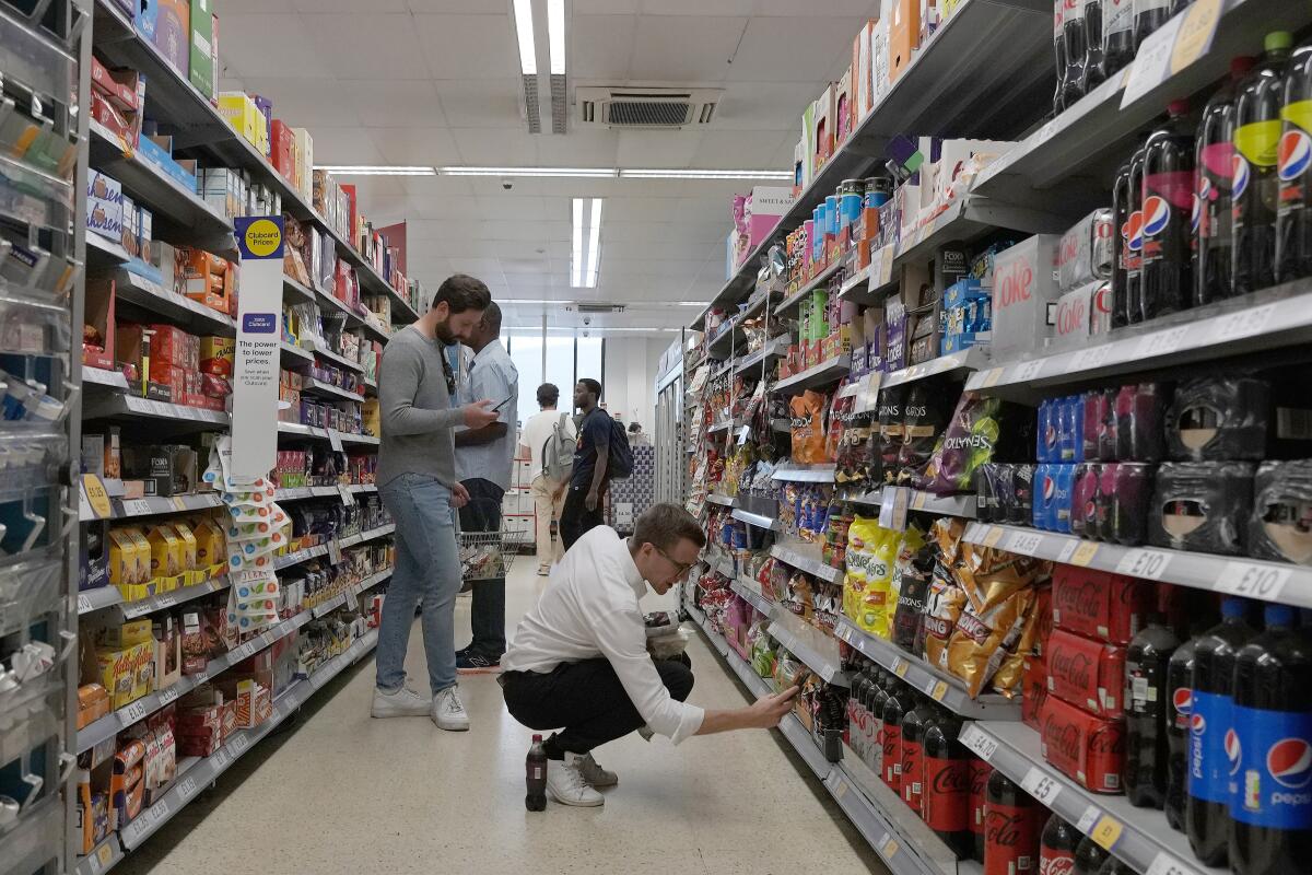 Shoppers buy food in a supermarket in London