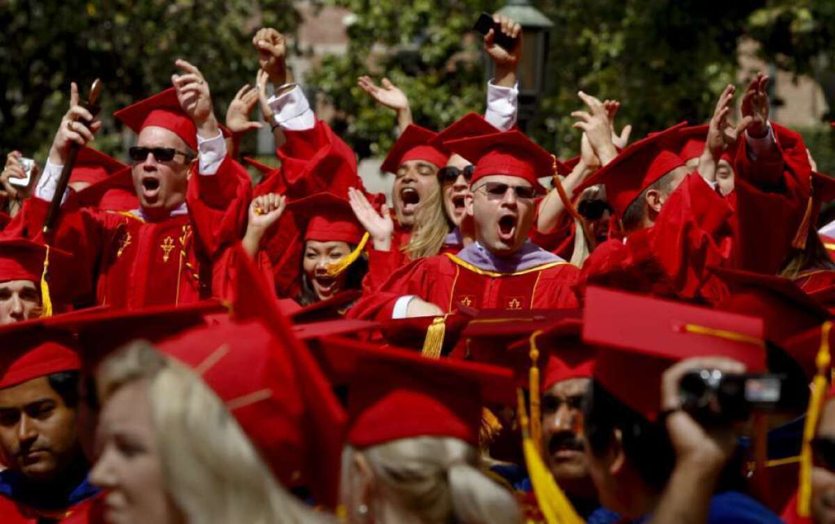 Some of the nearly 14,000 students receiving degrees are among the estimated 40,000 people filling Alumni Park at USC for the 129th annual graduation ceremony.