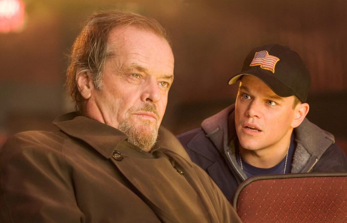 Matt Damon talks to Jack Nicholson who stares straight ahead in a scene from “The Departed”