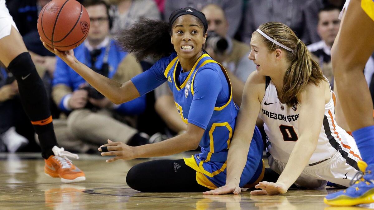 UCLA guard Jordin Canada looks for a teammate to pass to while on the court next to Oregon State's Mikayla Pivec during the second half Saturday.