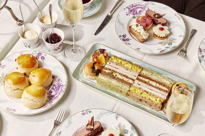 Afternoon tea at London’s Savoy Hotel, including tea, scones and crustless sandwiches.