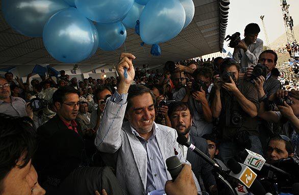 Abdullah Abdullah prepares to let loose balloons during his campaign rally.