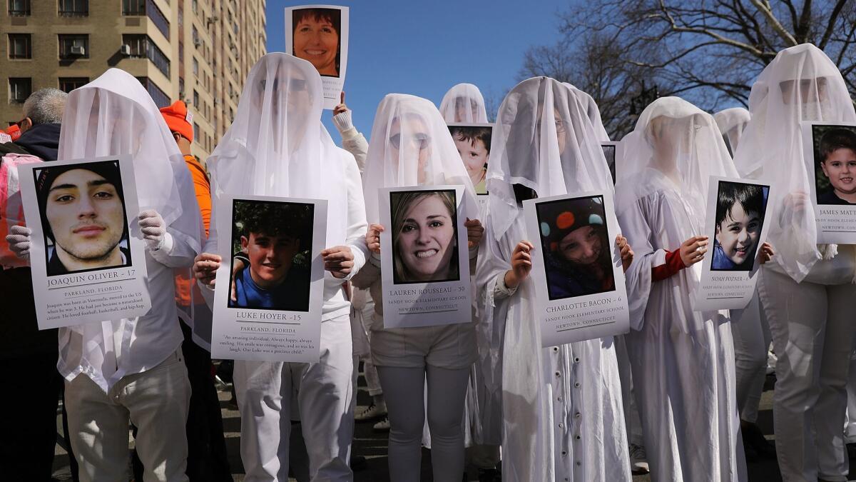 NEW YORK: Shrouded demonstrators holding pictures of victims of gun violence join the March for Our Lives in Manhattan.