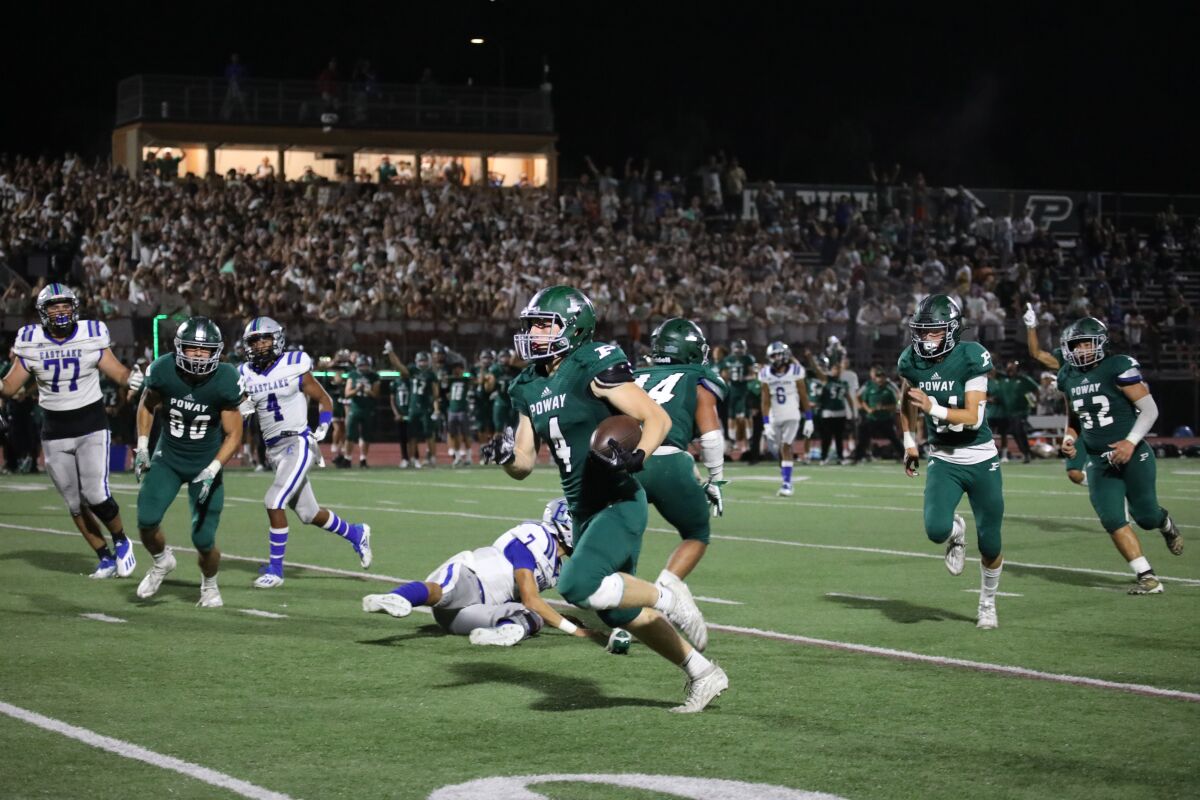 Poway’s Gabe Taylor runs an interception back for a touchdown against Eastlake. The Titans play Torrey Pines this week.