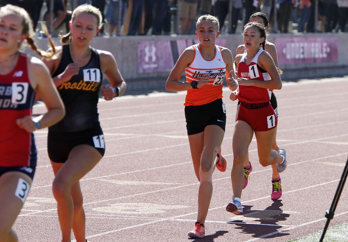 Huntington Beach's Quinn Roldan (22) competes in the girls' 1,600-meter run.