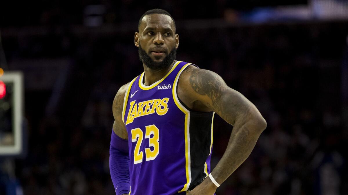 Lakers star LeBron James looks on during the team's 143-120 loss to the Philadelphia 76ers on Sunday.