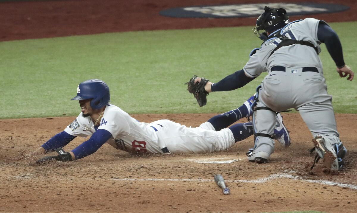 Dodgers right fielder Mookie Betts scores ahead of the tag of Rays catcher Mike Zunino in Game 6 of the 2020 World Series.